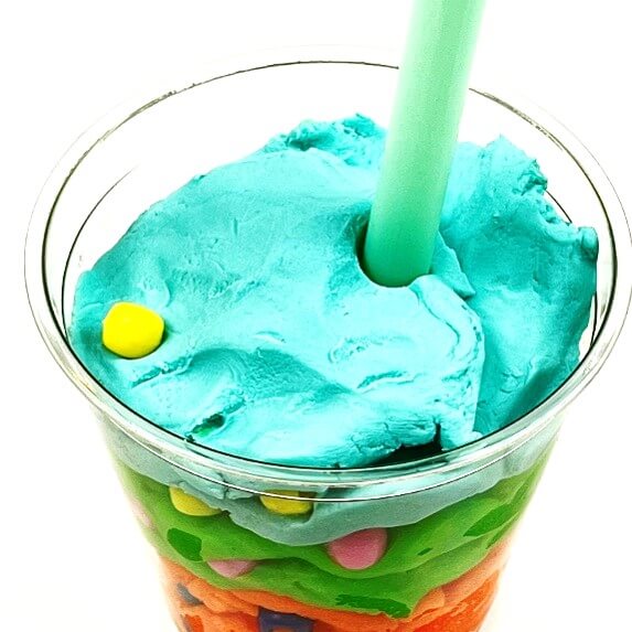 Play-Doh and colored beads to make geologic time scale models in a cup.